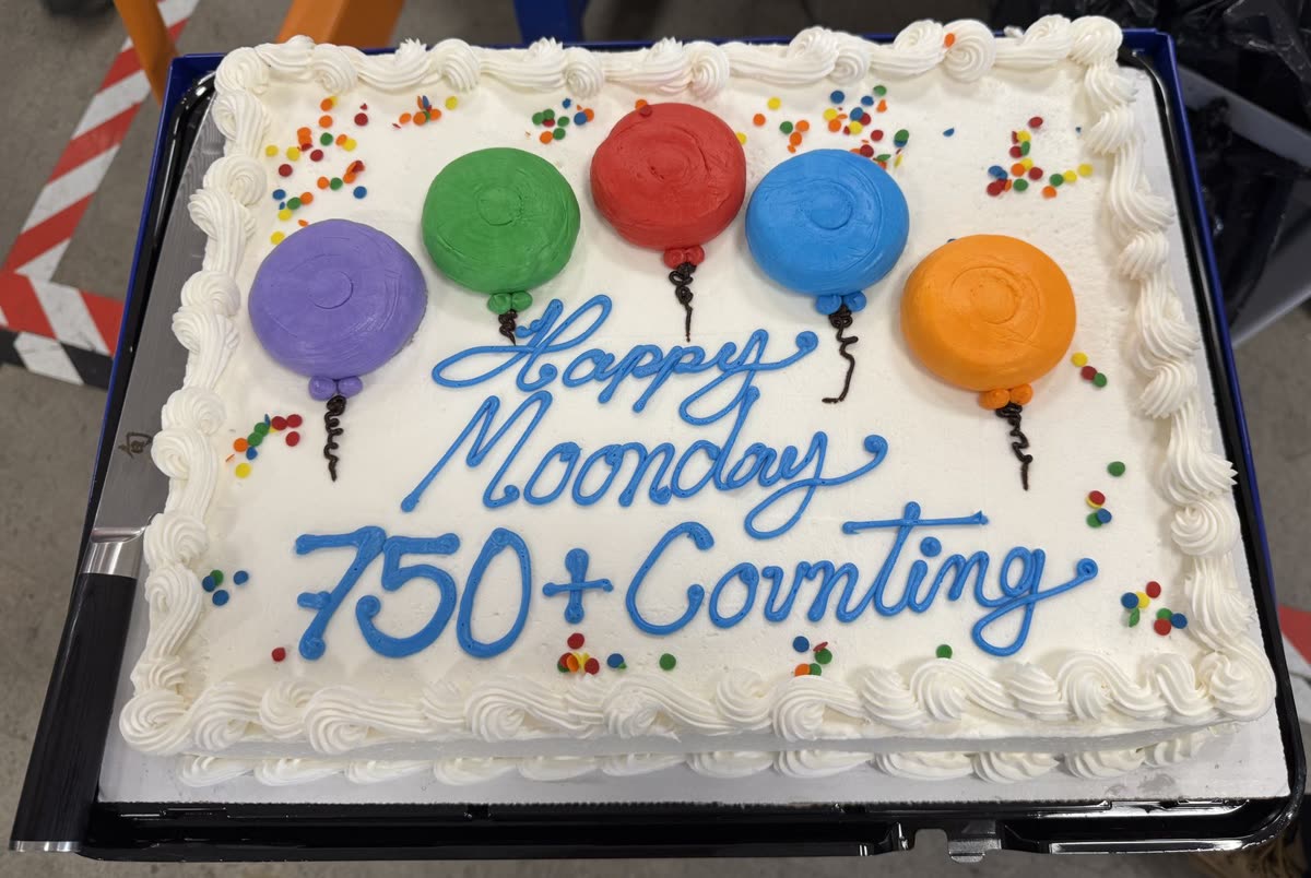 Sheet cake with frosting balloons that reads Happy Moonday 750 + Counting